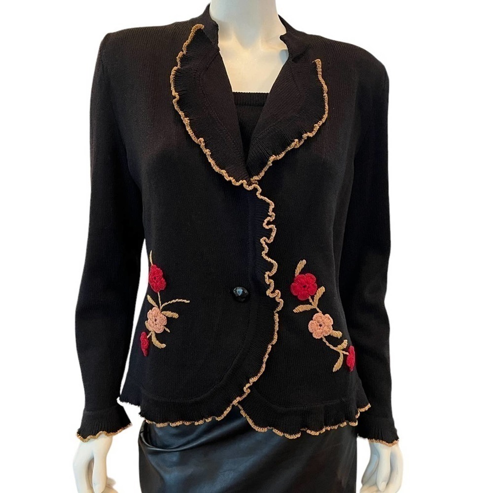 Gia on a black knit sweater with embroidery SZ. M